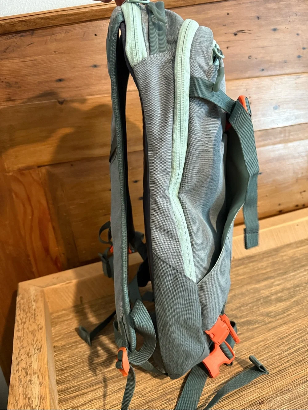 Dakine Mint tinted heli pack 12 backpack with Orange Buckles